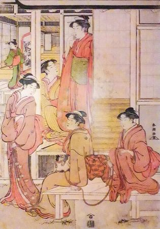 Grupa kobiet z kotkiem na progu domu